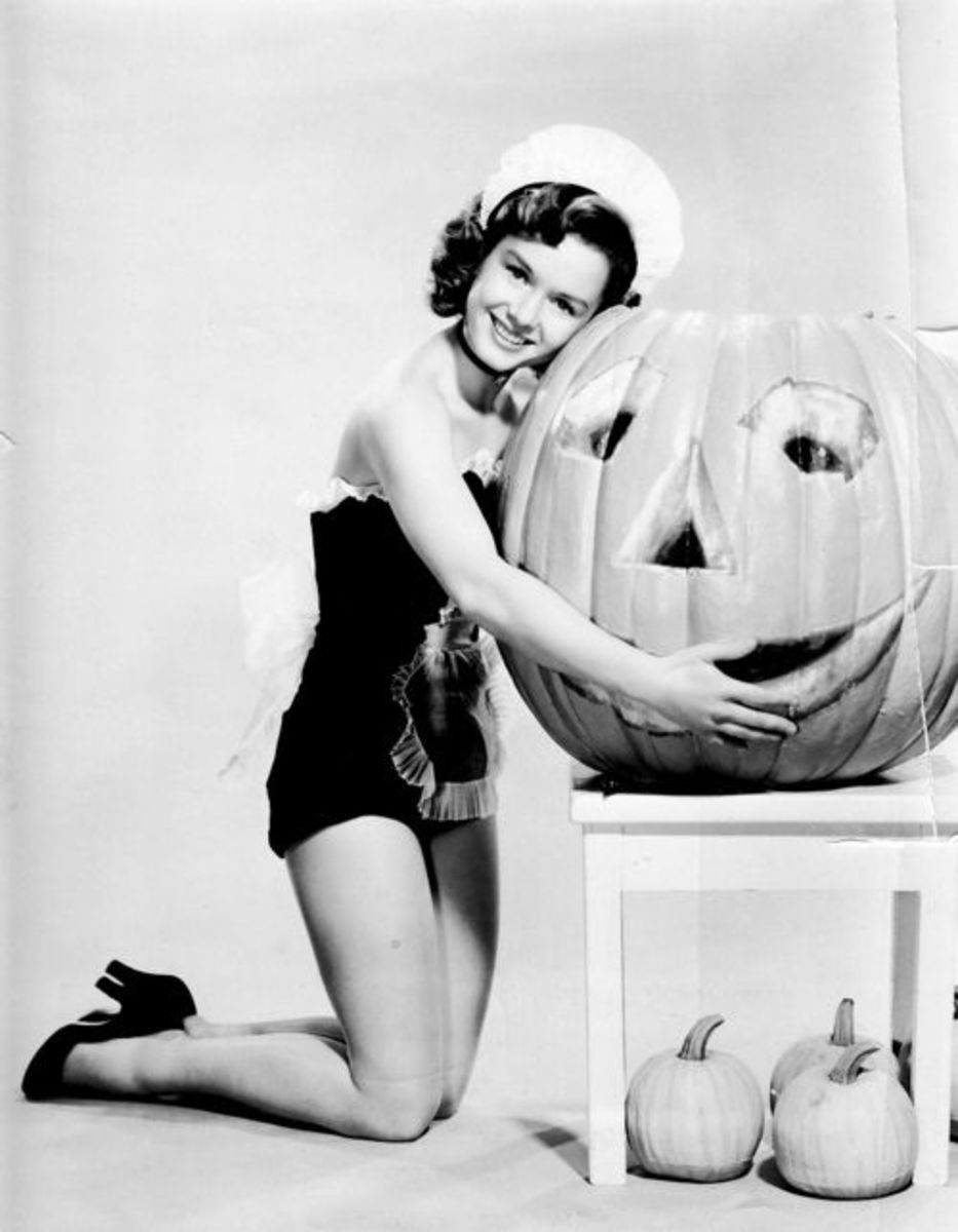 Fun fact: Beloved actress and singer Debbie Reynolds never had to carve a pumpkin - she would just hug it and it would smile. The fact that she's wearing a French maid's outfit in this 1953 publicity photo doesn't hurt.