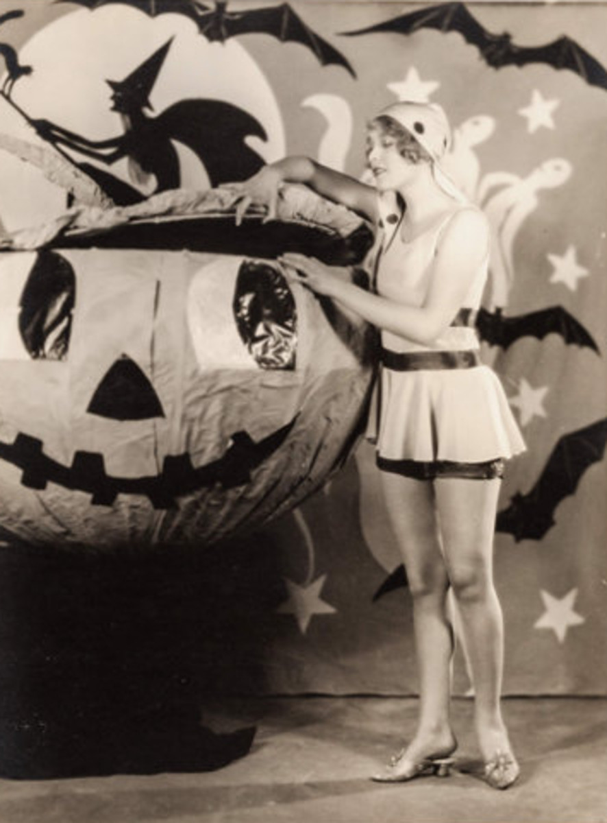 A playful pinup of silent-screen actress and vaudeville star Esther Ralston on a spooky Halloween pumpkin set shot by fashion photographer Eugene Robert Richee, Paramount, c. 1920s.