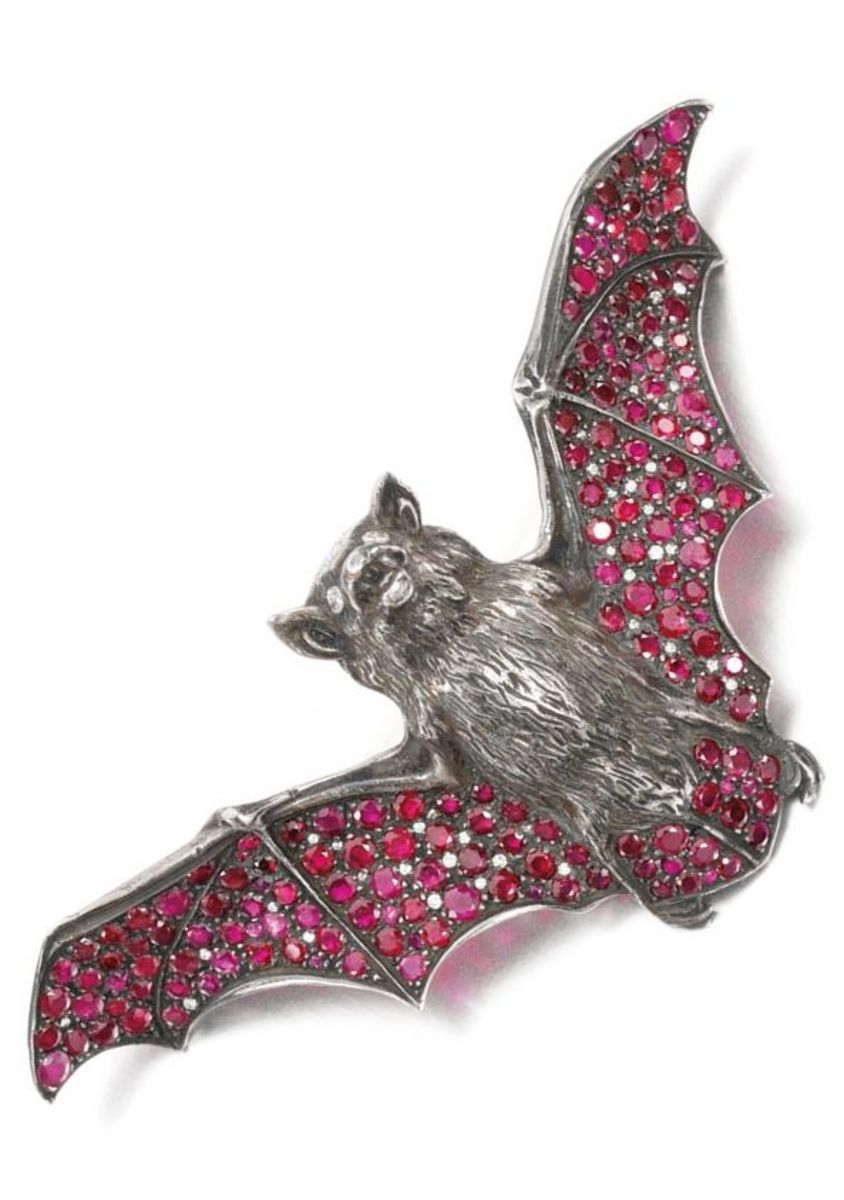 An antique ruby and diamond bat brooch, circa 1900, the wings pavé-set with circular-cut rubies and diamonds, the eyes composed of marquise-shaped diamonds, attributed to André Aucoc; valued between $42,573-$64,400.