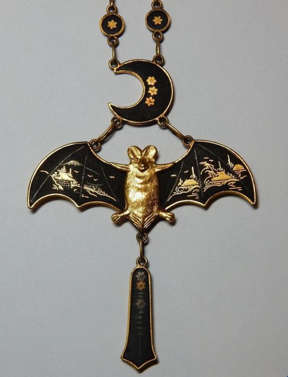 A rare Art Nouveau Japanese 24k silver-inlaid damascene bat and crescent moon necklace.