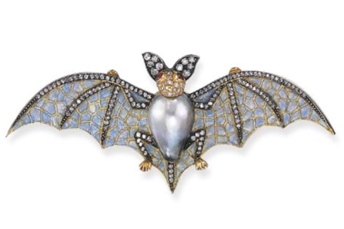 This bat brooch has a gray baroque pearl body with extending translucent light blue enamel and single-cut diamond wings and the gold head has cabochon ruby eyes and single-cut diamond ears. This sold at Christie’s for $3,055.