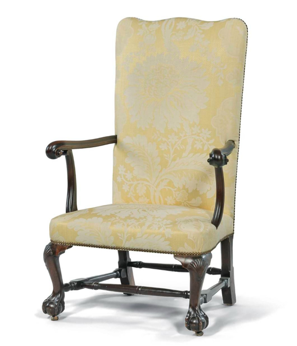 Chippendale carved mahogany open armchair, probably Providence, Rhode Island, c. 1765. The serpentine crest above an over-upholstered back and seat, with molded and shaped arms ending in scrolled handholds on shaped supports, the seat frame joining frontal cabriole legs with shell and bellflower-carved knees and claw-and-ball feet. Estimate: $50,000-$100,000.