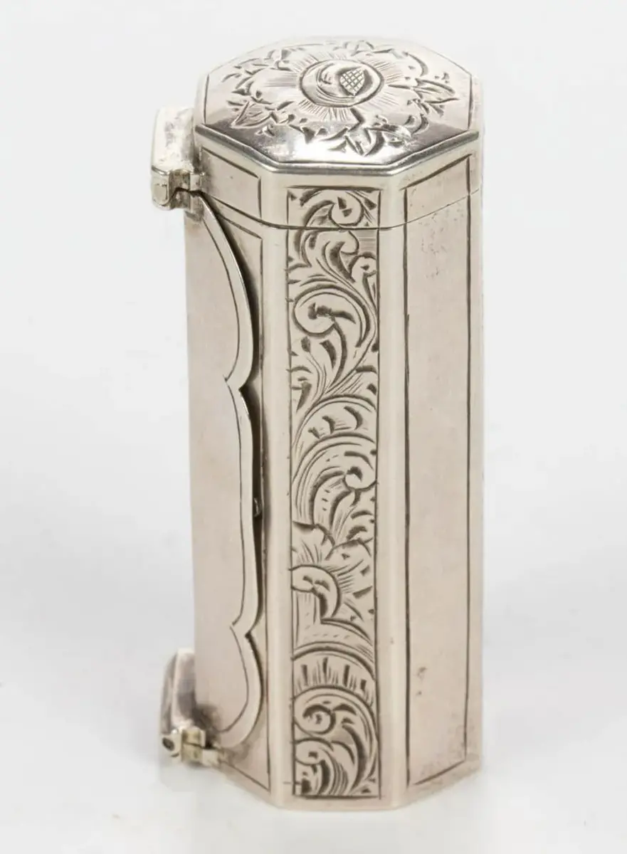 A Dutch silver nutmeg grater, octagonal cylindrical form, with engraved decoration along the side panels and top, Jan Gijsbert Koen of Amsterdam and Rhenen, circa 1858, 2-5/8"; $300.