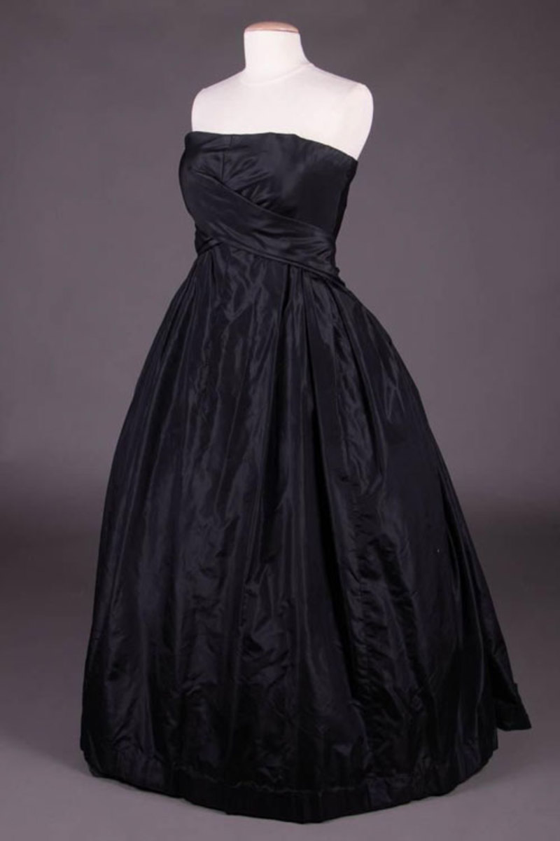 Christian Dior creations are timeless and this black strapless ballgown, circa 1958, is no exception. Made of silk taffeta, it has an asymmetrical wrapped front bodice formed from crossed back skirt panels. It was owned by Elena Jofré Serey de Chavez (1908-1987) of Santiago, Chile, wife of a Chilean diplomat.  Estimate: $1,200-$1,800.
