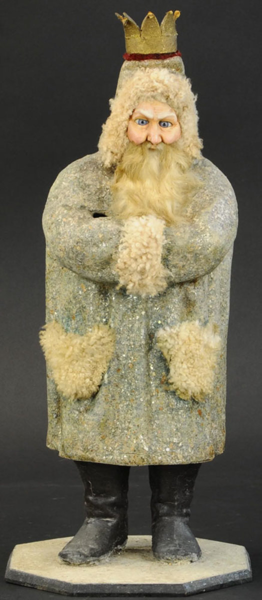 A early Belsnickle candy container made of snow-flecked composition, mohair trim, porcelain-like composition face, rabbit fur beard and piercing blue glass eyes; 20" h. Sold for $19,000 in 2020.