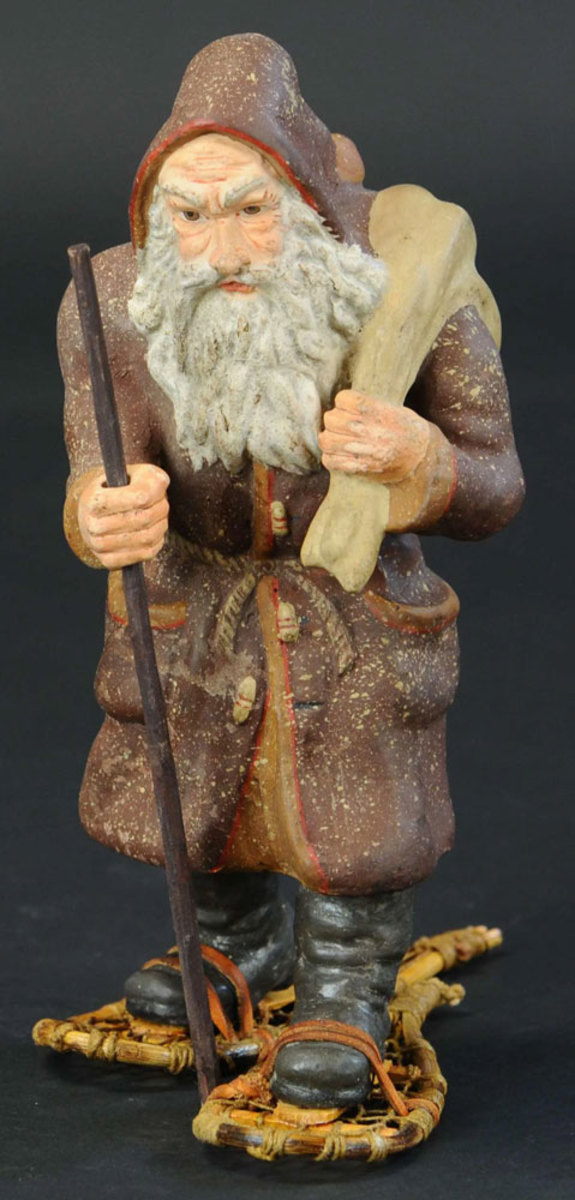 A rare and early chalk-like German Belsnickle walking with a stern and determined look on his face as he makes his Christmas Eve rounds on his snowshoes; 10” h. This sold in November for $2,250.