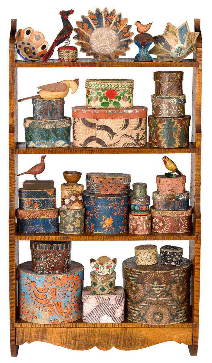 A tiger maple shelf, mid-18th c., holds an instant collection of vibrant color and form: a fine collection of around 34 Pennsylvania German small wallpaper boxes, pin cushions, and carvings begun by Mr. and Mrs. Paul Flack of Bucks County, Pennsylvania; estimate: $15,000-$20,000.