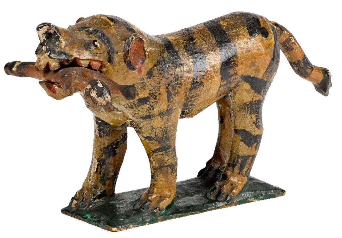 Rare and large carved and painted pine figure of a tiger devouring a soldier by Wilhelm Schimmel, ca. 1880; estimate: $40,000-$60,000.