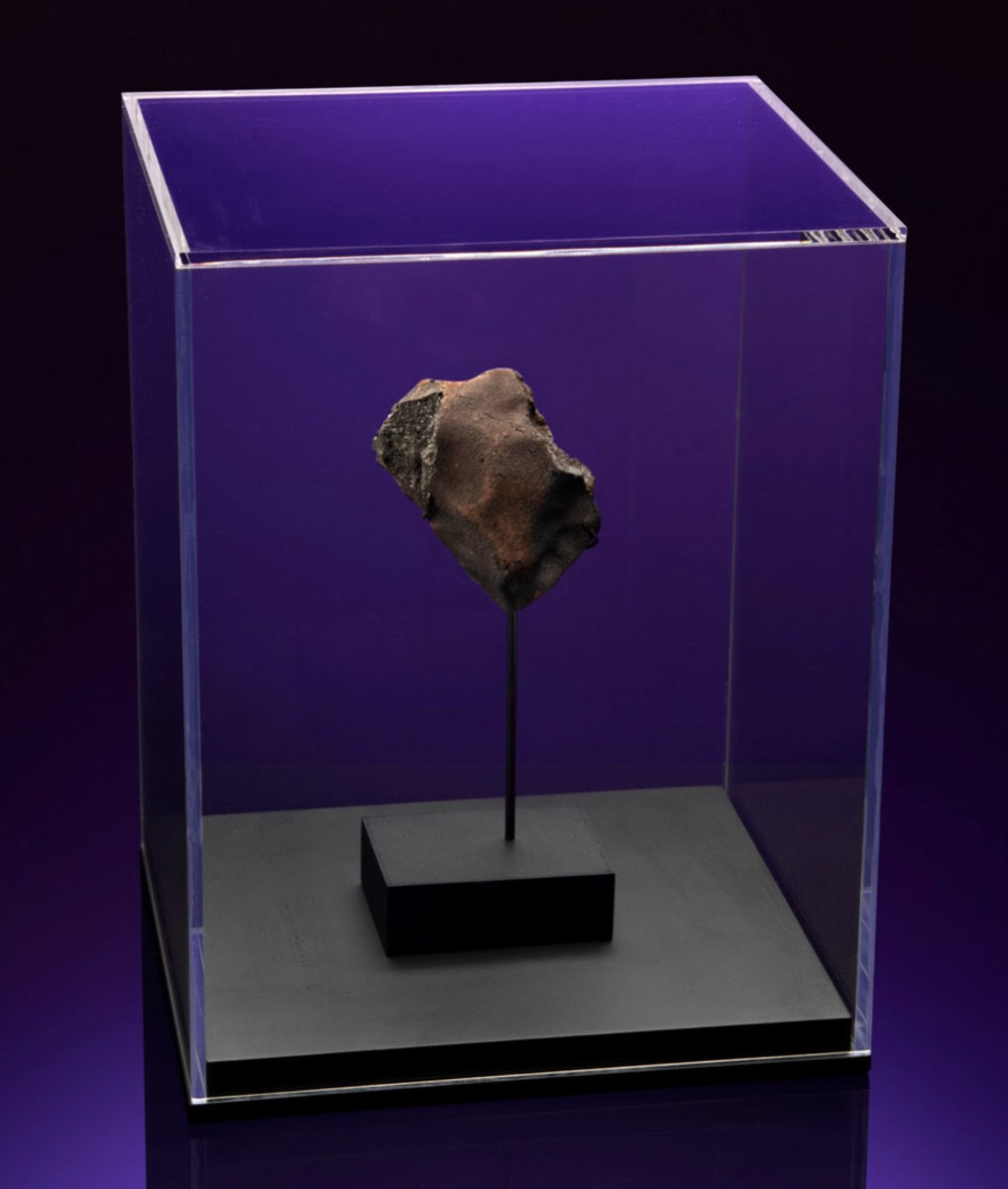 This piece of Aguas Zarcas CM2 meteorite, about 3" x 3" and weighing .33 pounds, punctured Roky's doghouse. It sold for $21,420.