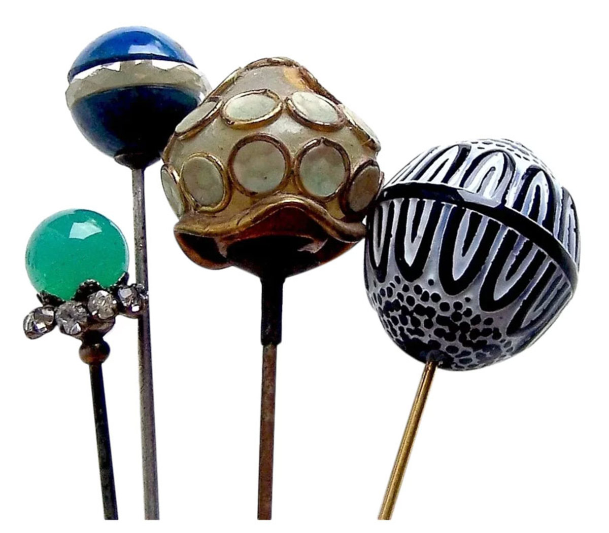 A collection of ceramic and fancy glass Edwardian hatpins, ranging from 8" h to 10" h; $150.