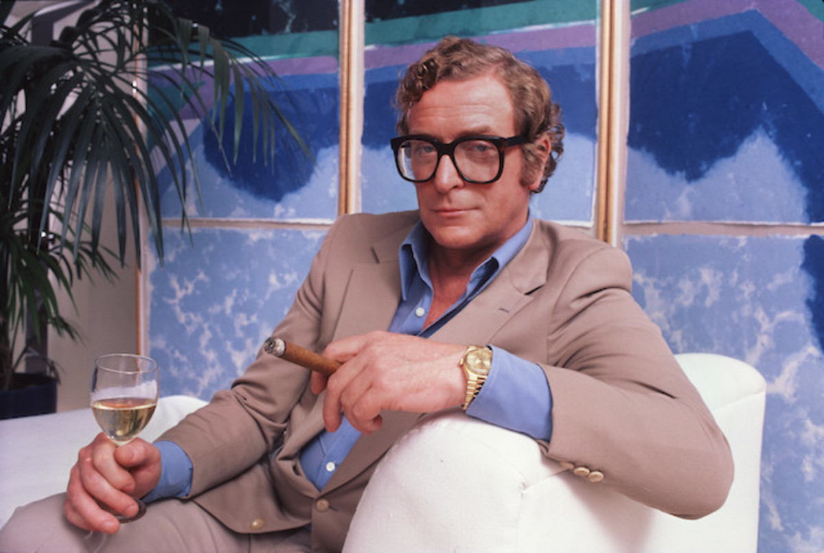 Michael Caine wearing his Rolex and a pair of his trademark glasses.