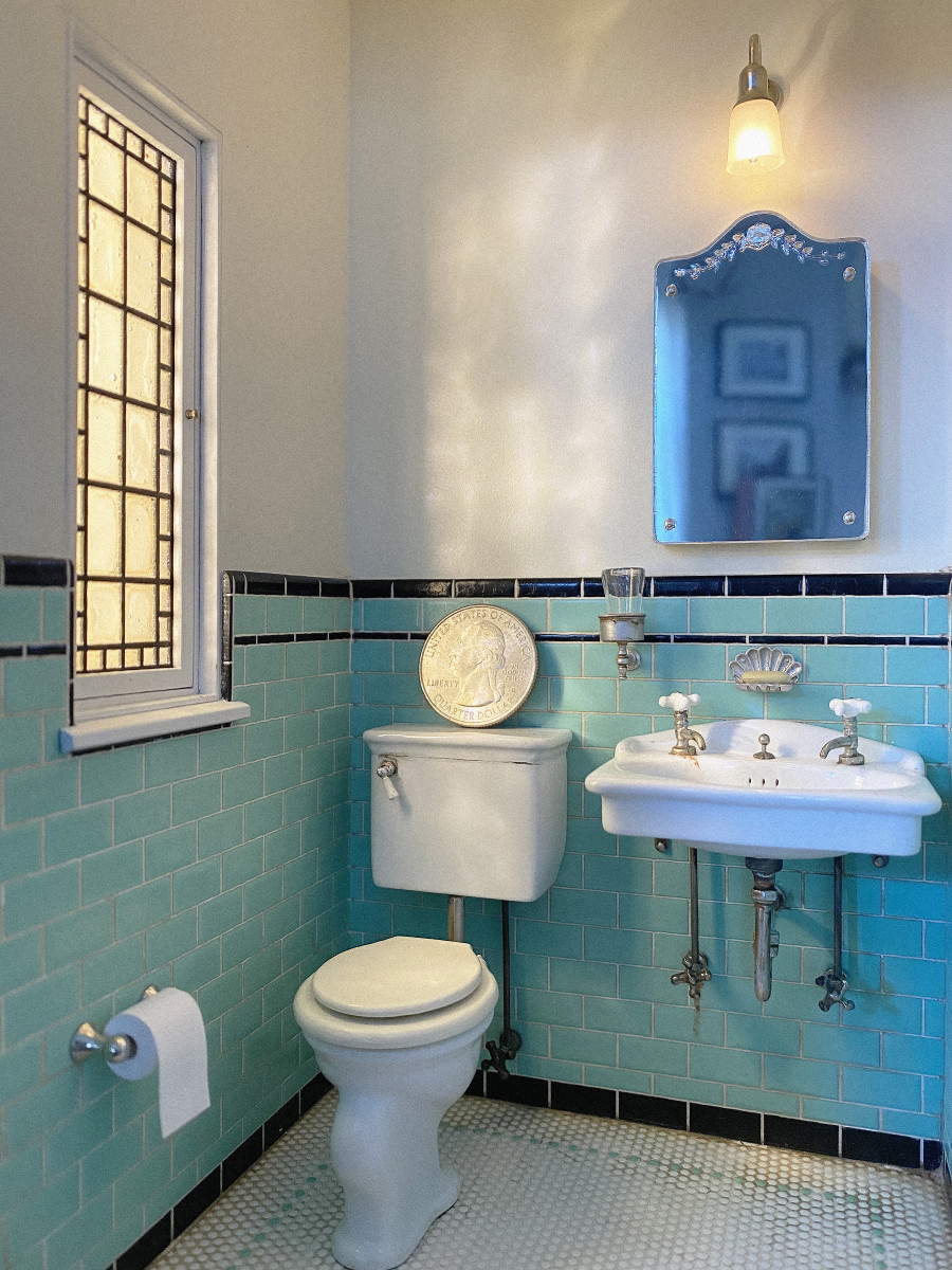 A 1929 powder room filled with tiny Art Deco details,  including the clamshell-shaped soap dish above the sink.