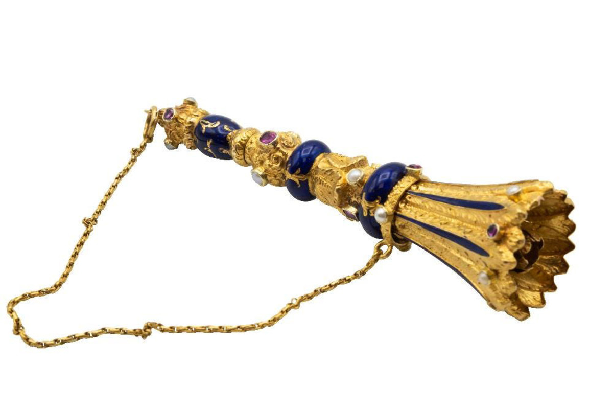 Gold and enamel posy holder, late 19th century, French import mark for Paris, decorated with collet-set rubies and pearls with cobalt blue enamel, 3-1/2” l; $3,875.