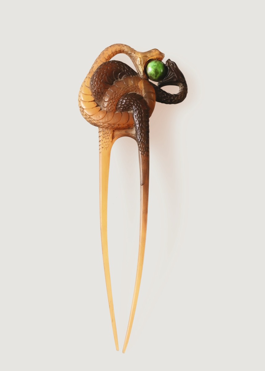 Deux Serpents: Snakes were a common motif of Lalique's, as this horn and turquoise hair pin attests. Designed as two entwined snakes, each bite the same ball shaped object, circa 1900-1905, around 8” h and 3” w. This sold at Sotheby’s in 2018 for $44,384.