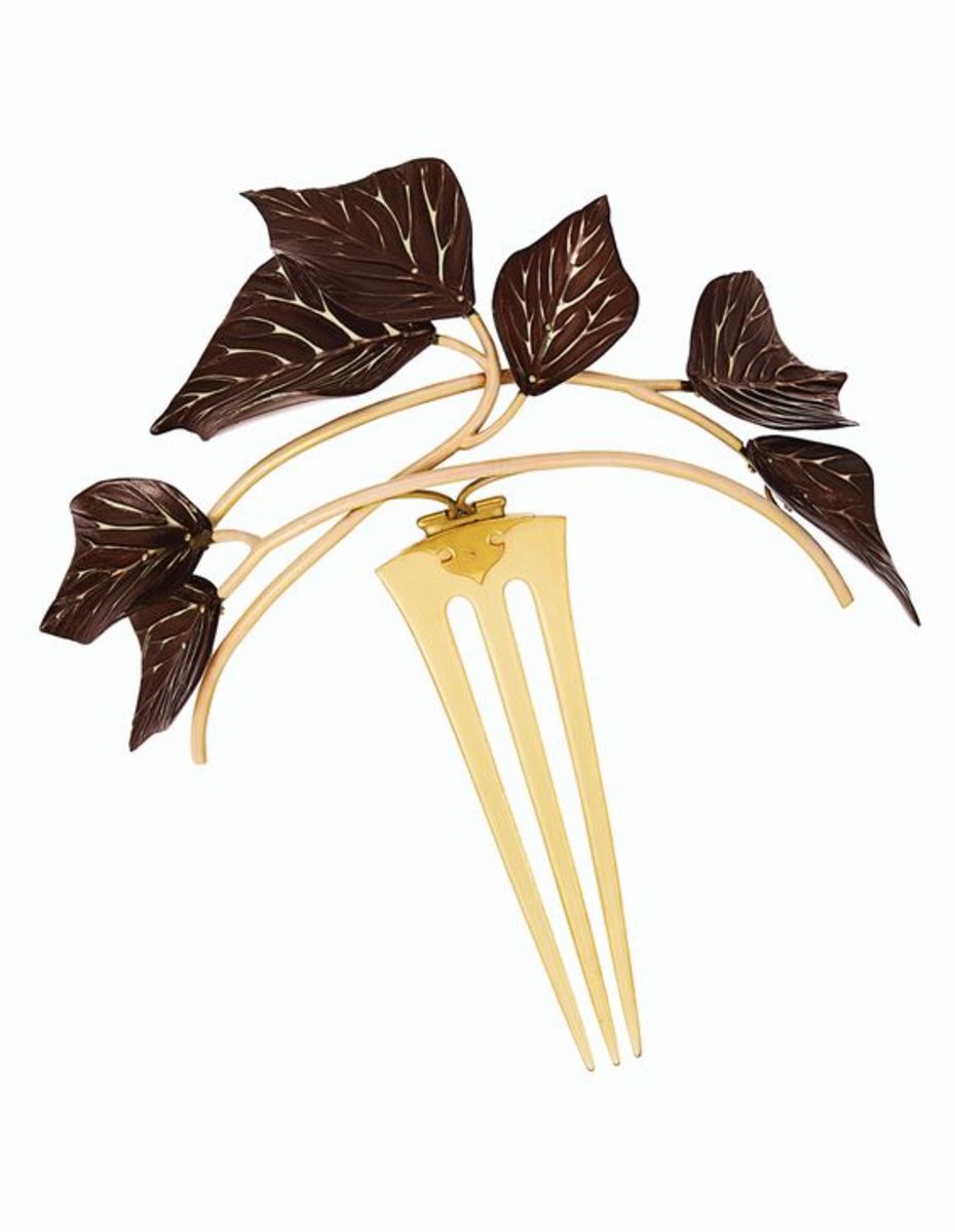 A tiara comb carved in horn and embellished with reddish brown and cream-colored enamel and 18k gold, circa 1890, 6-1/2". This sold at Christie’s in 2019 for $50,000.