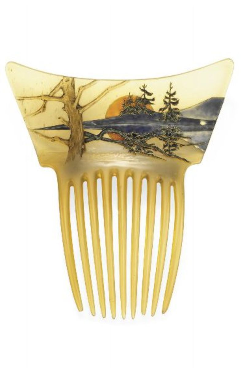 Orange Sun Landscape: In the second half of the 20th century, the land of the rising sun was opening up to the rest of the world, and Japanese art was beginning to inspire many European artists, including Lalique. He decorated this horn comb, circa 1900, with a blue and green enameled mountain landscape and trees at sunrise. The scene is reflected in water, creating a mirror image. In the foreground, a leafless tree anchors and balances the composition; 5-1/4" x 4-1/2". This sold at Christie’s in 2009 for $92,500.