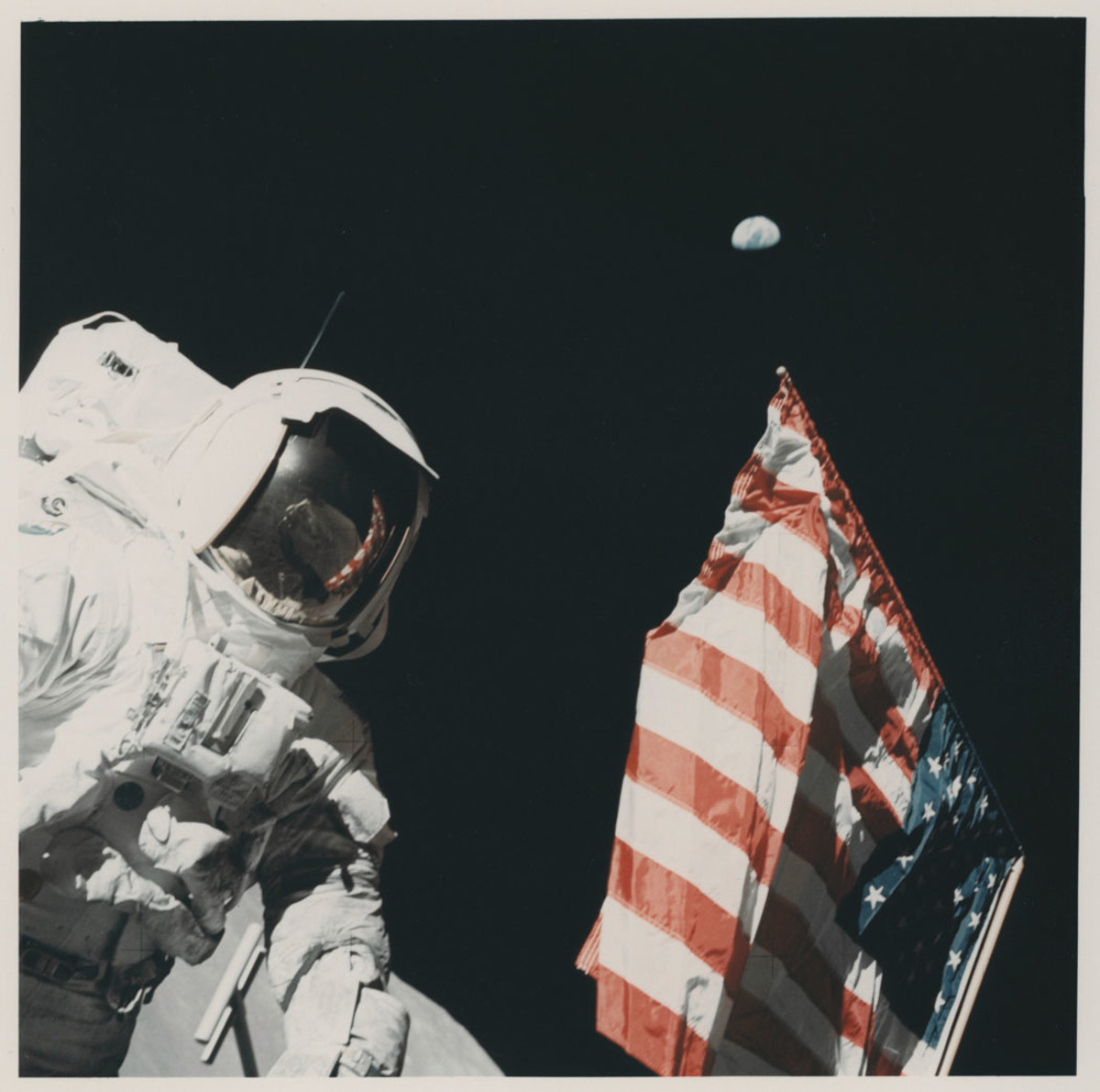During the final mission of NASA’s Apollo program (December 7-19, 1972), Apollo 17 Astronaut Harrison “Jack” Schmitt stands on the moon beside the U.S. flag planted by him and Mission Commander Eugene A. Cernan, whose image reflects in Schmitt’s visor. A beckoning Earth floats nearly a quarter of a million miles away. The image sold at auction for $3,750.