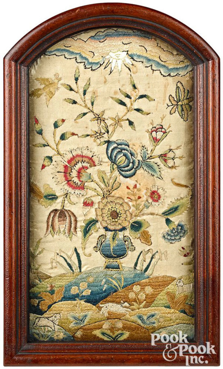 Philadelphia silk on silk pictorial embroidery by Ann Marsh, ca. 1730, with vibrant urn of flowers with insect and bird, all resting on a rolling lawn with sheep and a running dog. The frame is a custom reproduction by Alan Andersen, 14-1/4" x 7-1/2". Estimate: $15,000-$25,000.