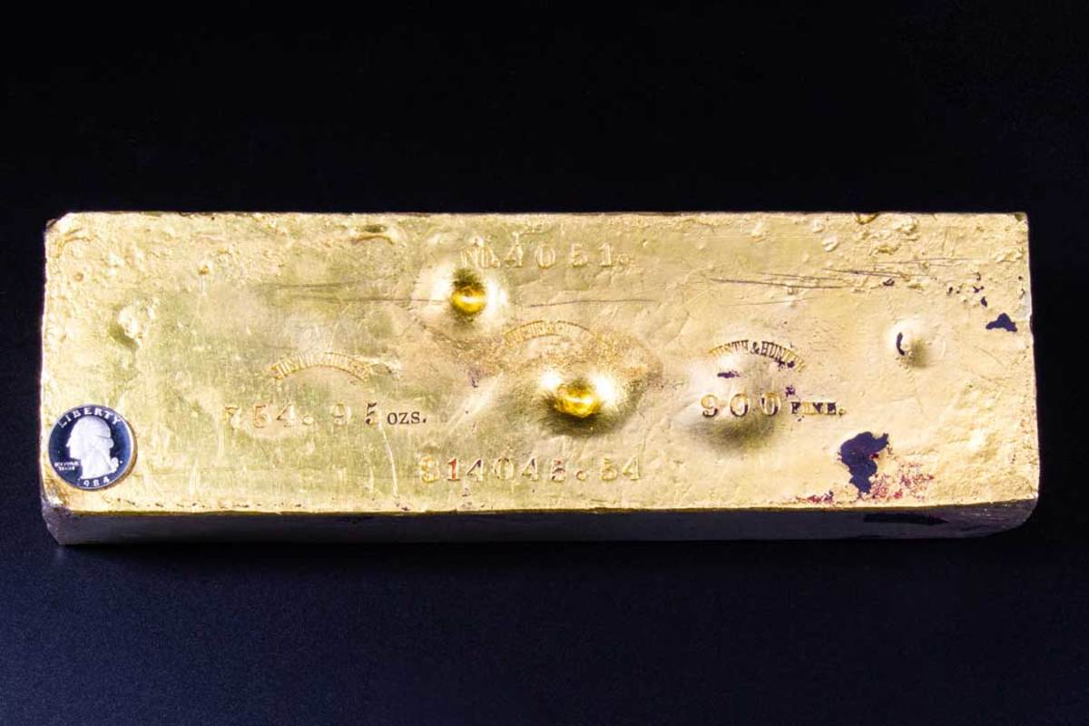With a quarter on it for size comparison, this large gold ingot recovered from the S.S. Central America has been sold for more than $2 million.
