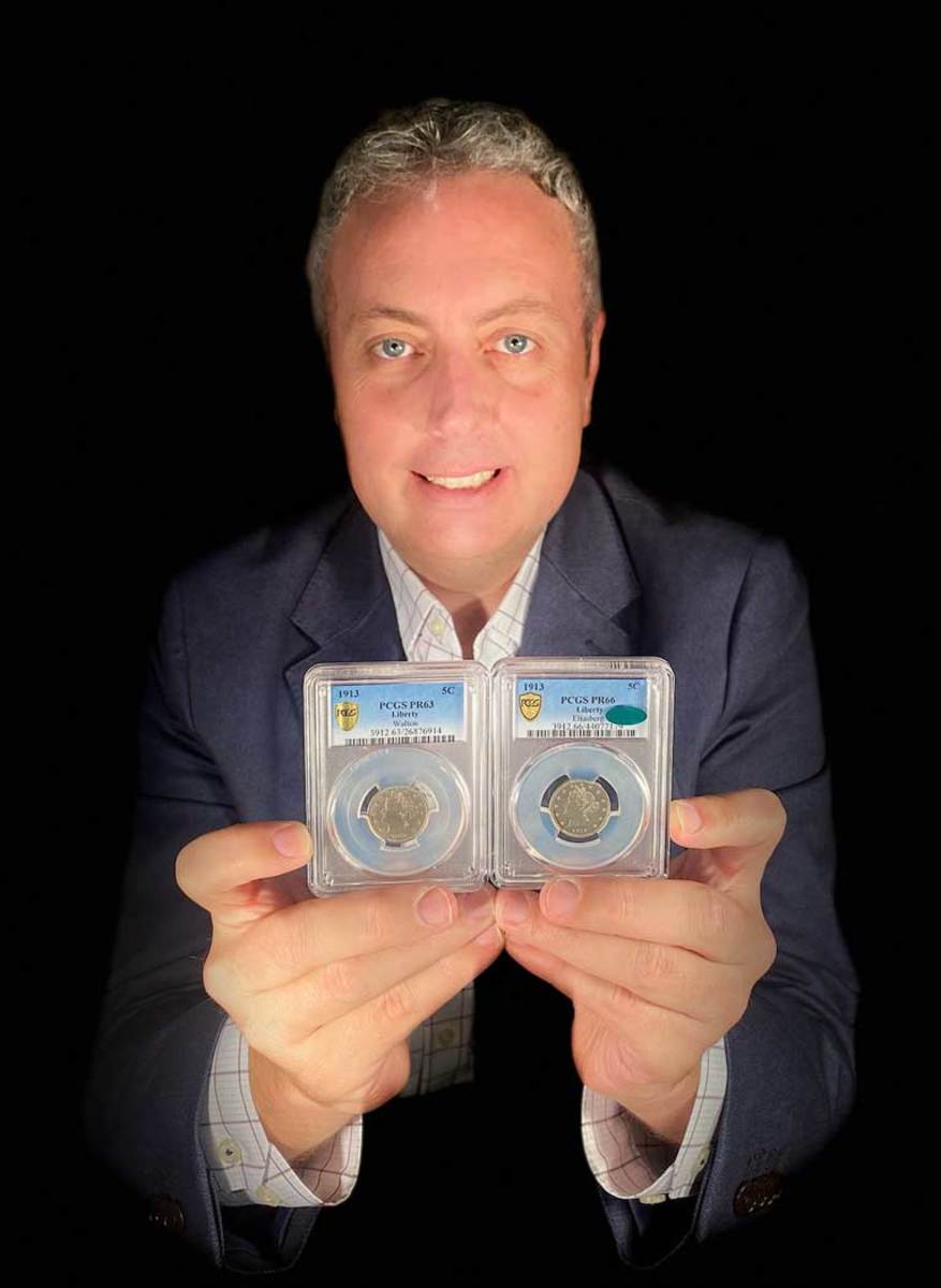 Ian Russell, president of GreatCollections in Irvine, California, holds two multi-million-dollar, rare U.S. 1913 Liberty Head nickels he has purchased in the past year, including the one on the left he just acquired from a Florida family for $4.2 million. Only five 1913-dated Liberty Head nickels are known.